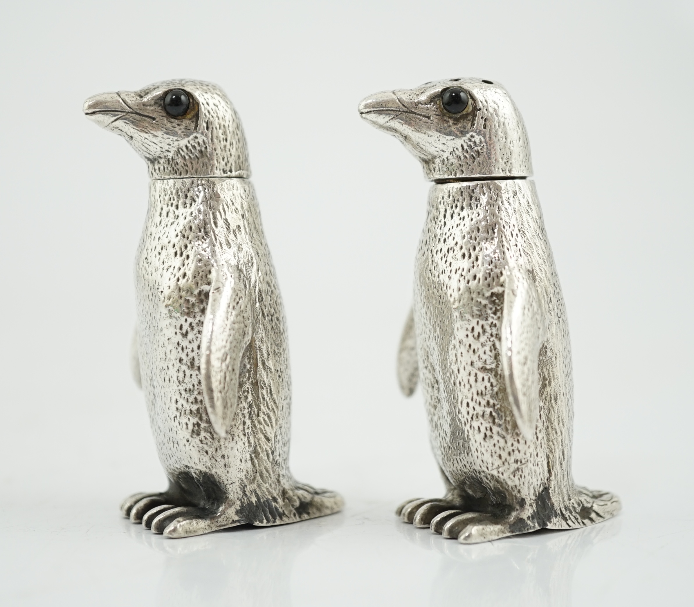 A pair of Elizabeth II silver novelty condiments, modelled as penguins, William Comyns & Sons Ltd